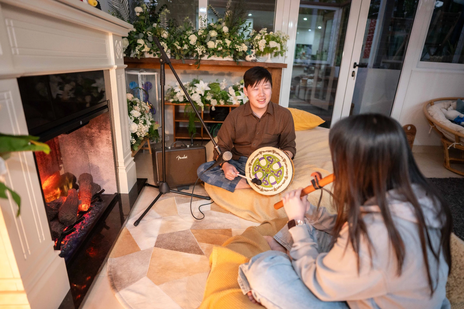 Music therapist seated with a client during a warm, indoor session