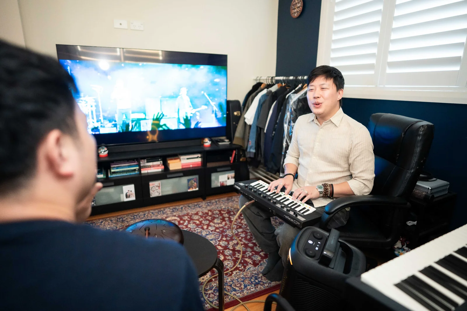 Music therapist playing keyboard with a client in a home-based session